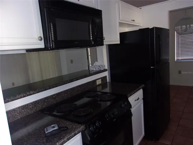 a kitchen with a stove and a microwave