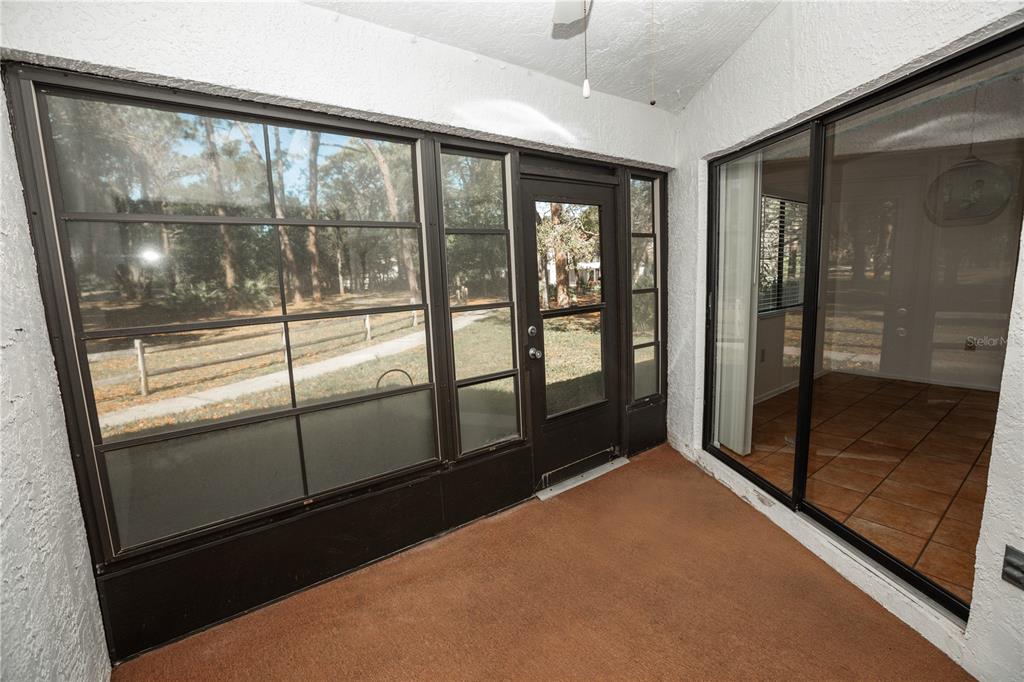 9410 Nakoma Way, Unit H Weeki Wachee, FL 34613 - Photo 23 of 29 a view of an empty room with glass door