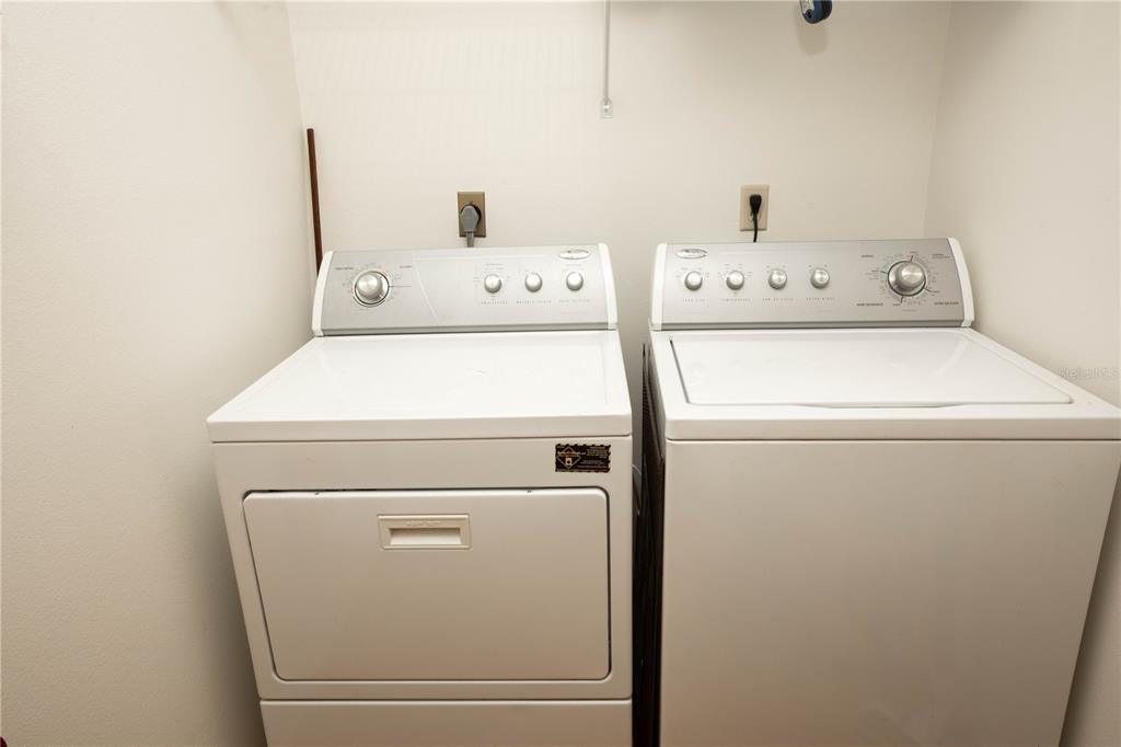 9410 Nakoma Way, Unit H Weeki Wachee, FL 34613 - Photo 24 of 29 a utility room with dryer and washer