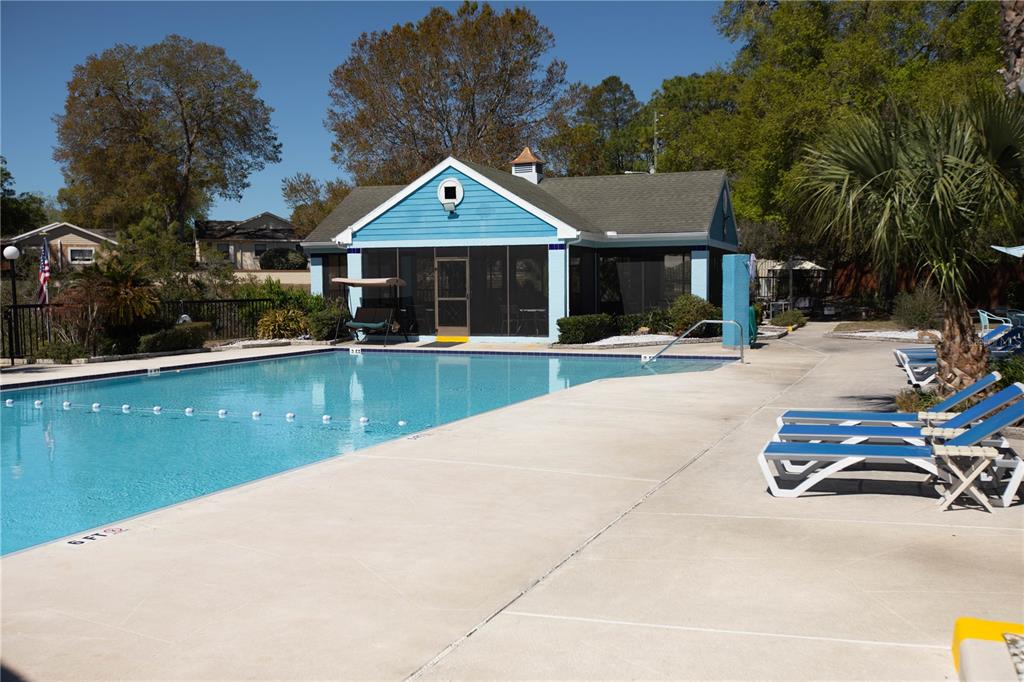 9410 Nakoma Way, Unit H Weeki Wachee, FL 34613 - Photo 27 of 29 a front view of a house with swimming pool and porch with seating space