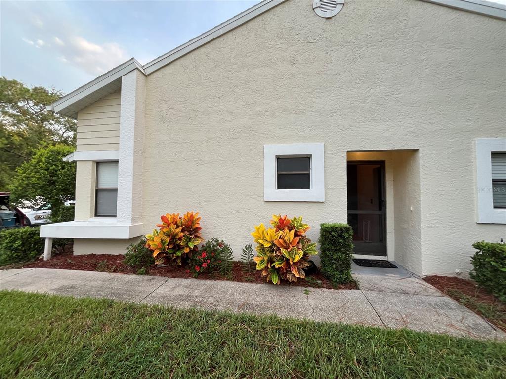 9410 Nakoma Way, Unit H Weeki Wachee, FL 34613 - Photo 3 of 29 a front view of a house with patio