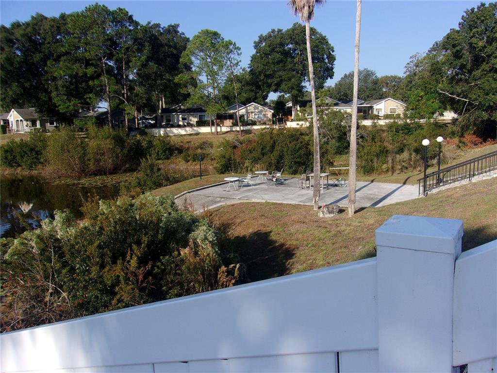 9410 Nakoma Way, Unit H Weeki Wachee, FL 34613 - Photo 10 of 29 a view of a yard with cars