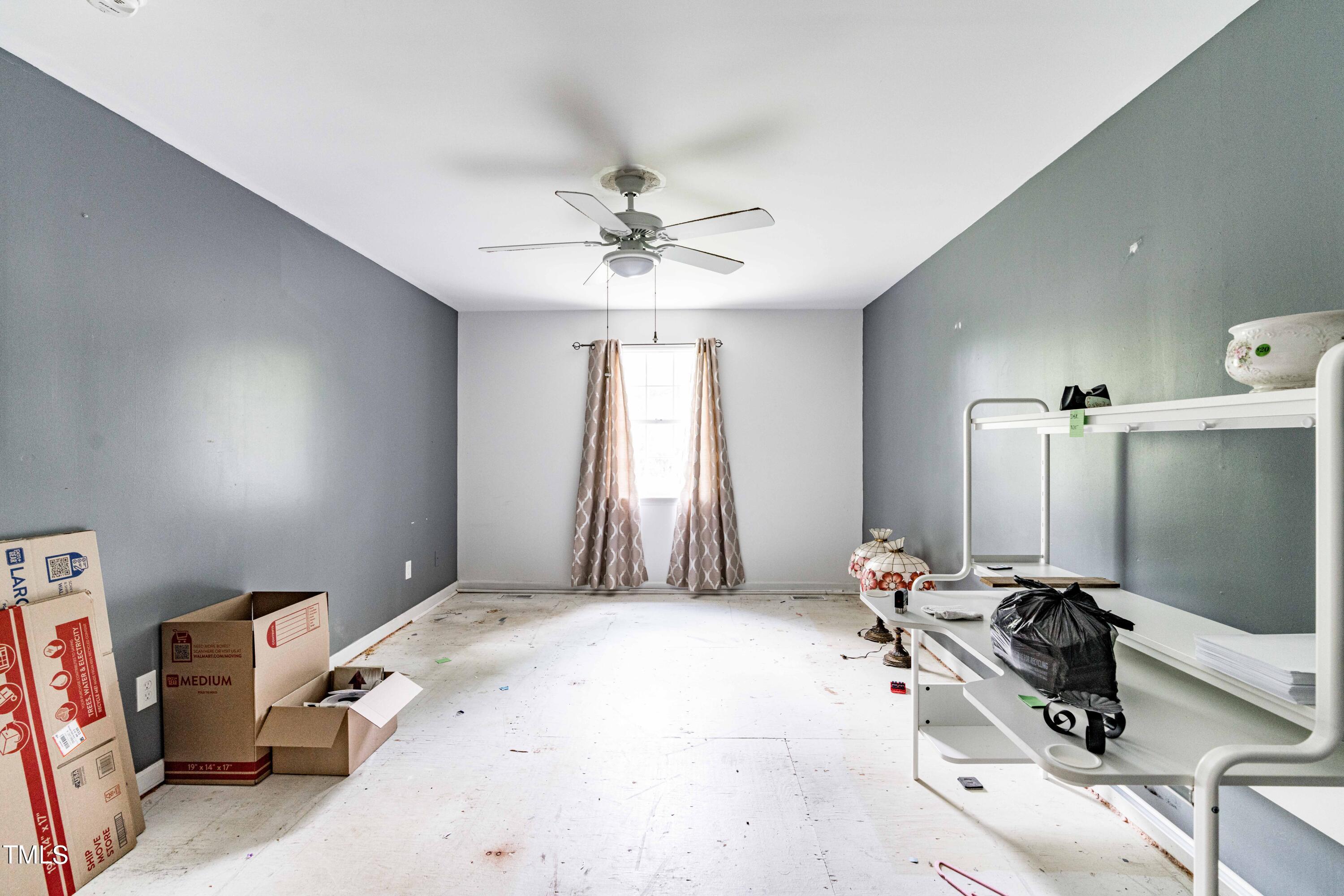 3417 Leonard Road Raleigh, NC 27610 - Photo 11 of 26 a bedroom with a bed and a chandelier
