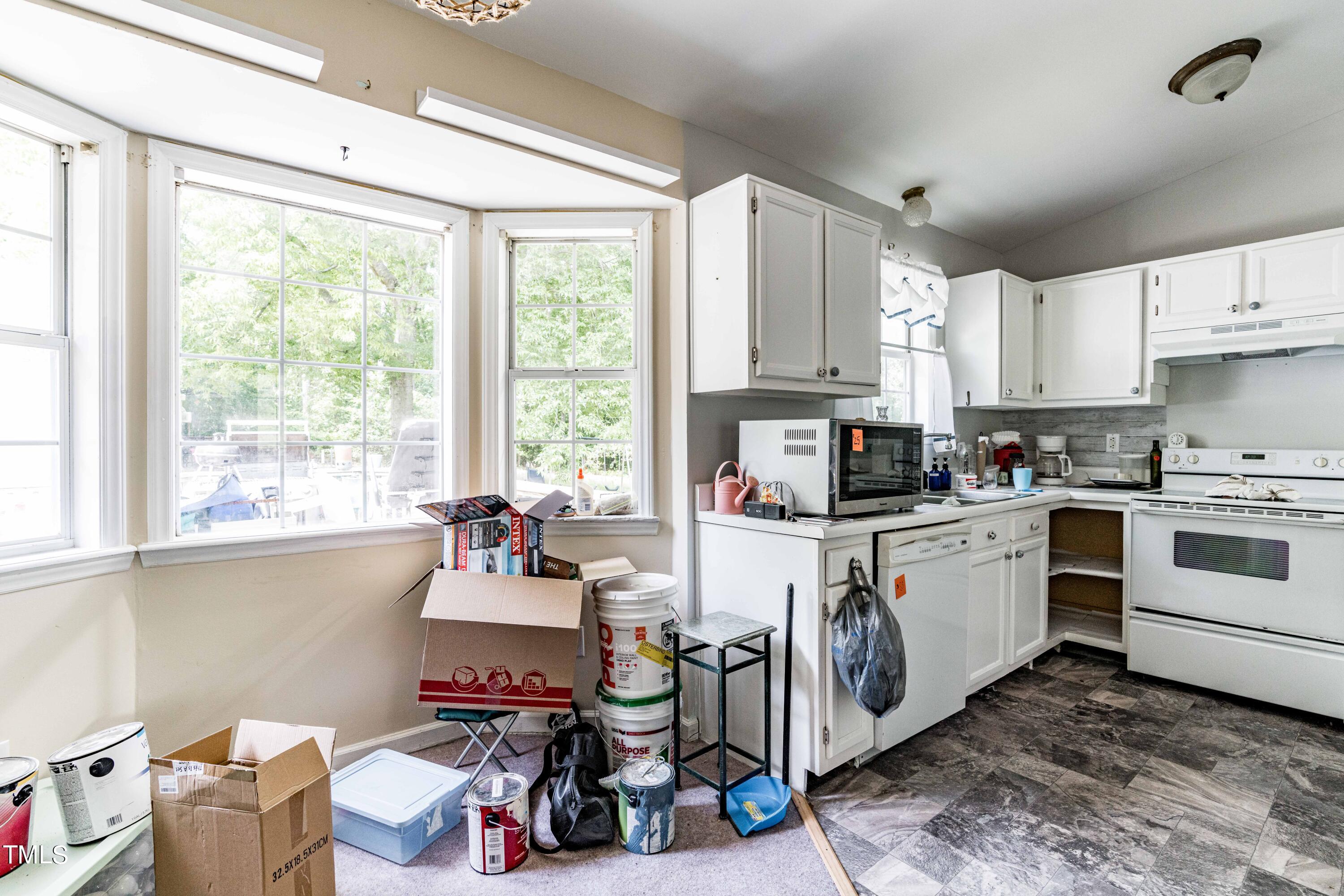 3417 Leonard Road Raleigh, NC 27610 - Photo 6 of 26 a kitchen with a window dining table and chairs