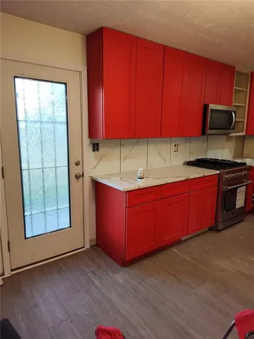 a kitchen with stainless steel appliances granite countertop wooden cabinets a sink and dishwasher