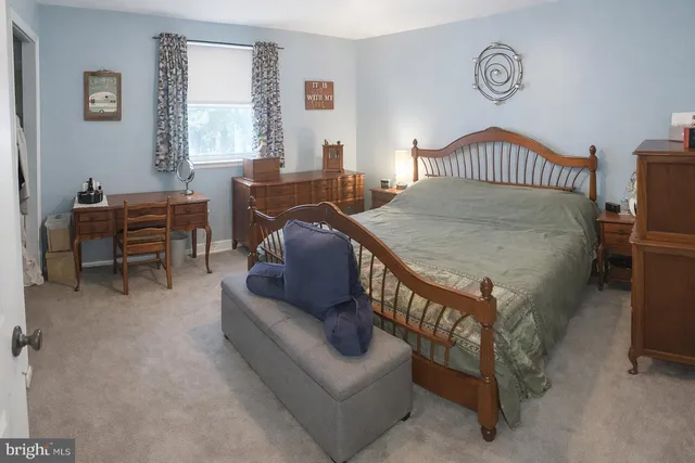 a bedroom with furniture and a window