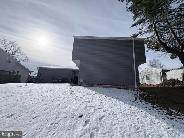 a wooden bench sitting in middle of a yard