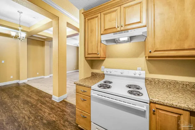 a kitchen with a stove and a refrigerator