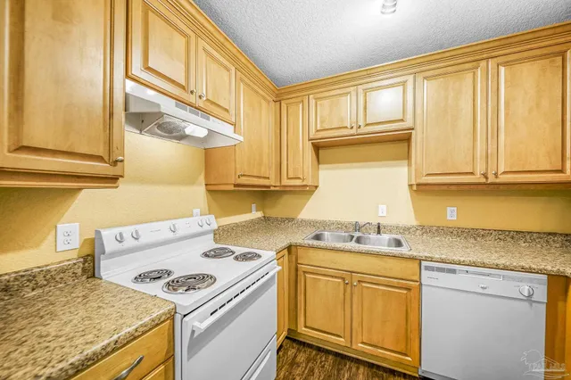 a kitchen with a sink stove and cabinets