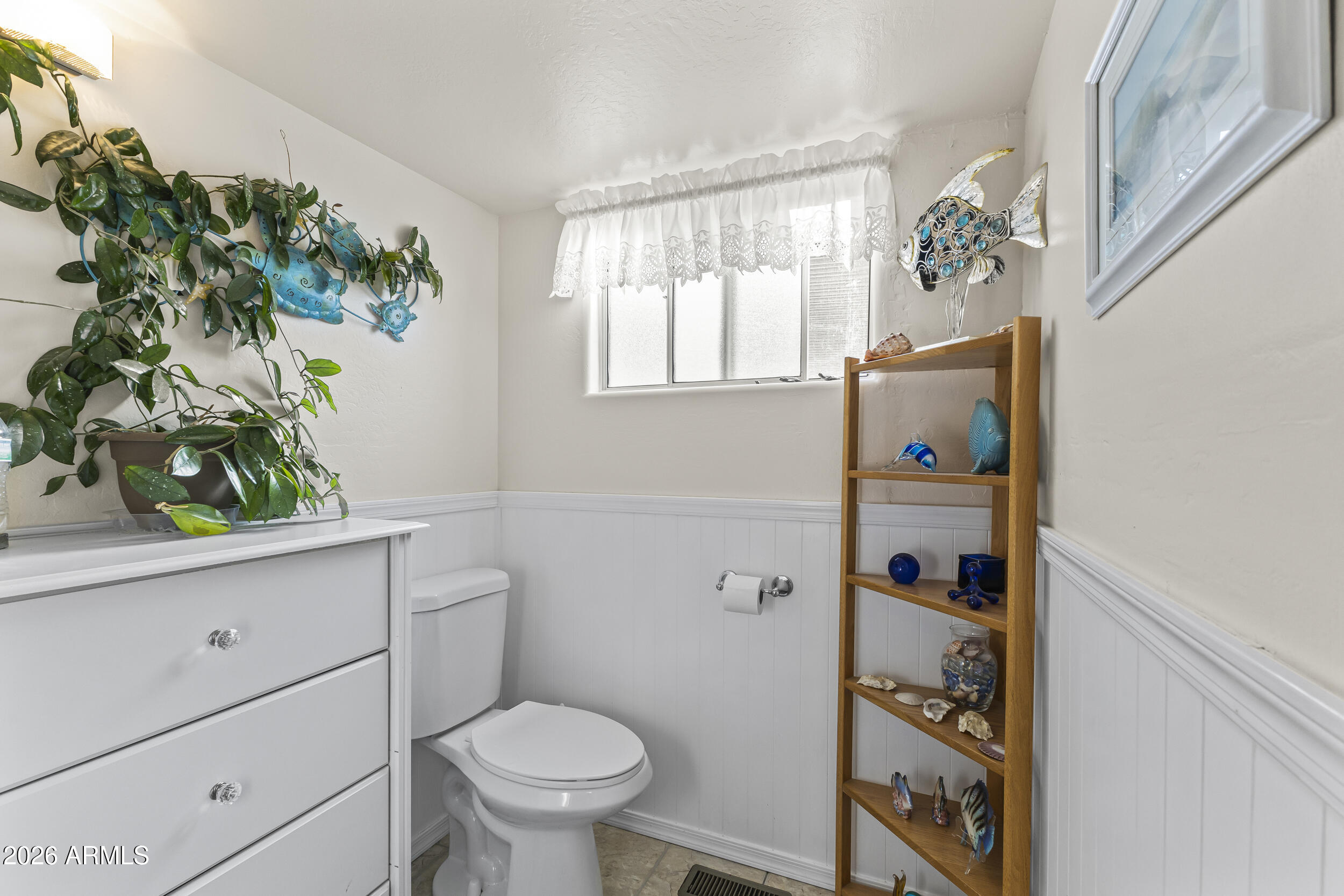 17200 West Bell Road, Unit 548 Surprise, AZ 85374 - Photo 15 of 19 a bathroom with a sink a toilet and a window