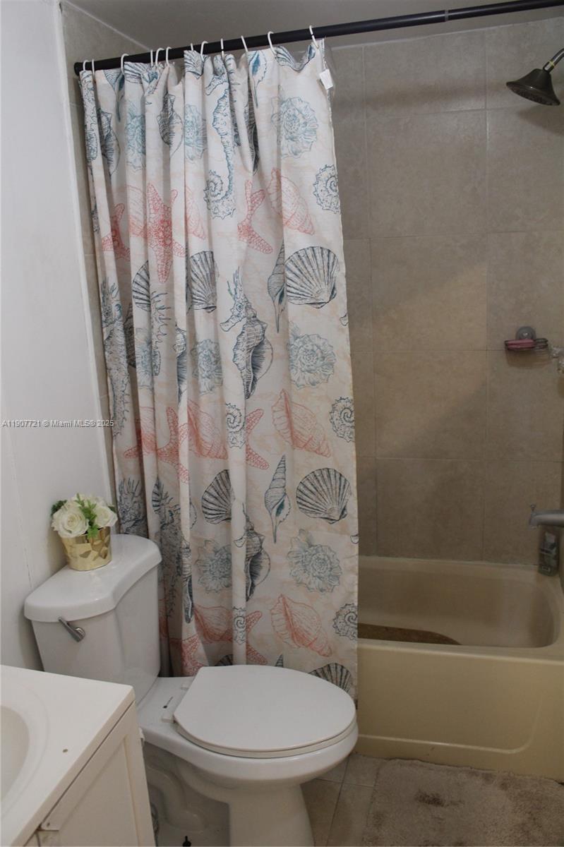 12841 Southwest 12th Terrace Miami, FL 33184 - Photo 11 of 16 a white toilet sitting next to a bath tub