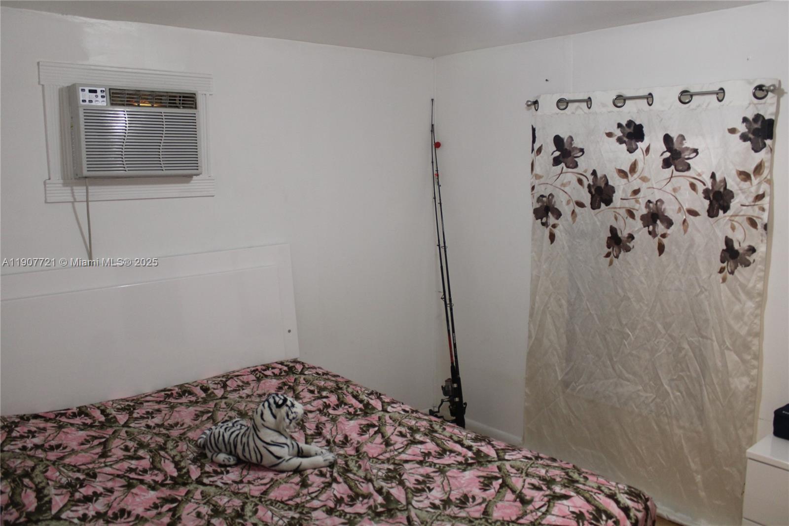 12841 Southwest 12th Terrace Miami, FL 33184 - Photo 12 of 16 a bedroom with a bed and a window