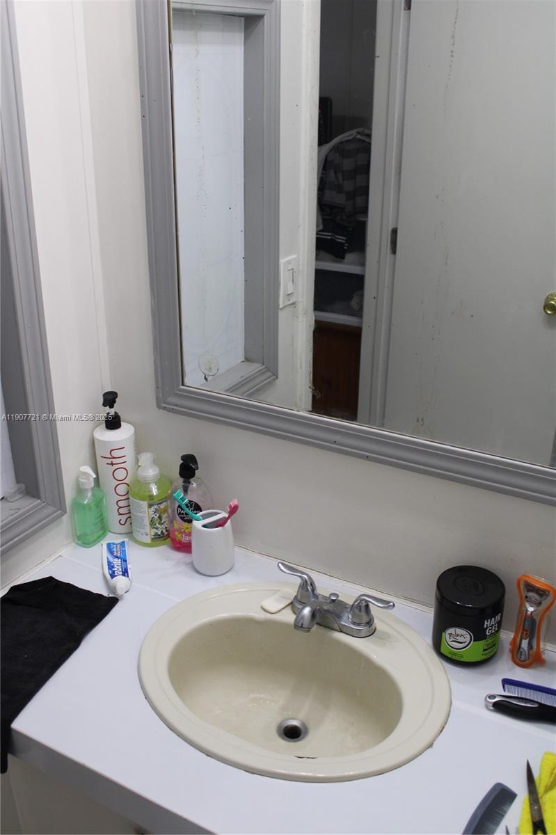 12841 Southwest 12th Terrace Miami, FL 33184 - Photo 16 of 16 a bathroom with a sink and a mirror