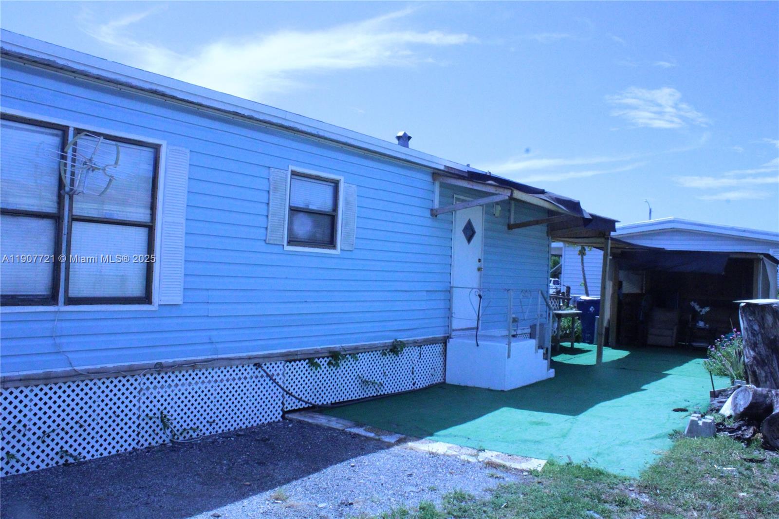 12841 Southwest 12th Terrace Miami, FL 33184 - Photo 2 of 16 a view of backyard with wooden fence and a large tree