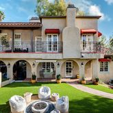 a front view of a house with swimming pool having outdoor seating