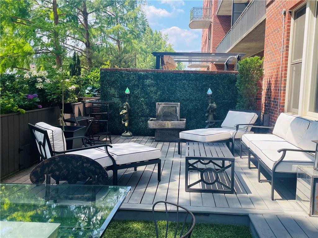 a view of a patio with table and chairs with wooden floor and fence