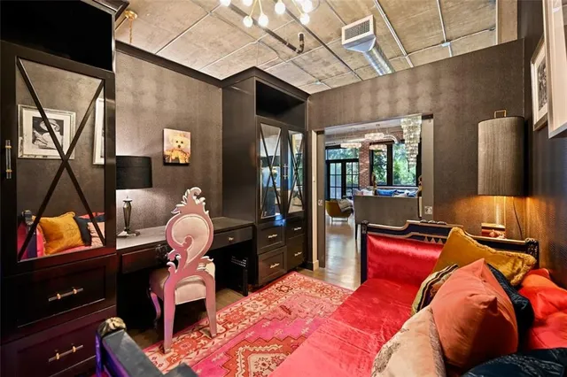 a living room with furniture and a open kitchen view