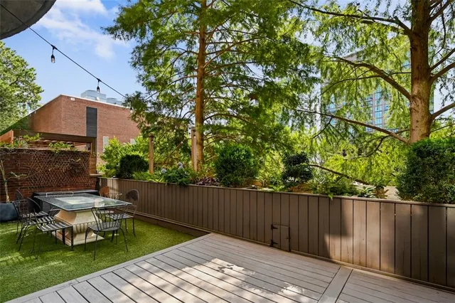 a view of balcony with wooden floor and outdoor seating