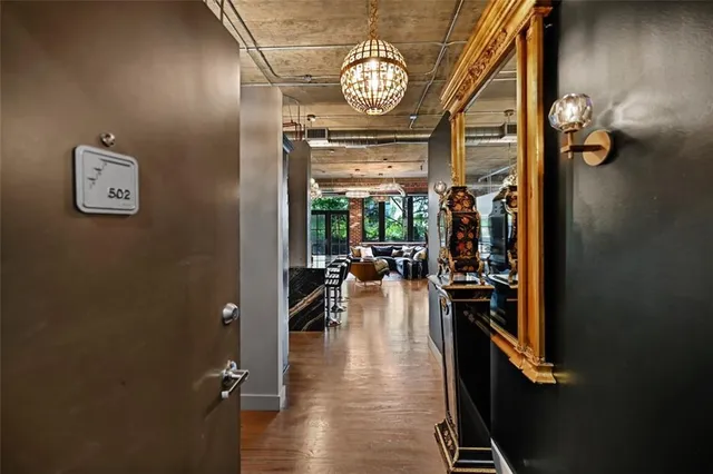 a view of living room with kitchen island granite countertop wooden floor and a view of living room