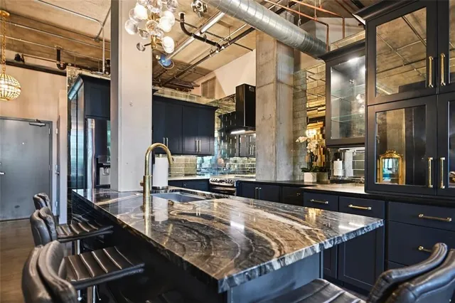 a kitchen with sink refrigerator and cabinets