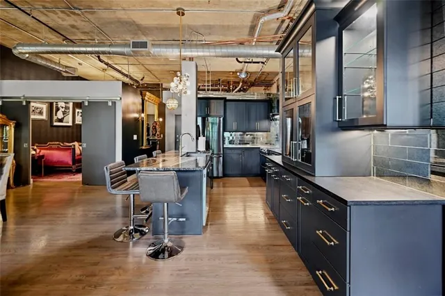 a kitchen with stainless steel appliances granite countertop a sink stove and cabinets