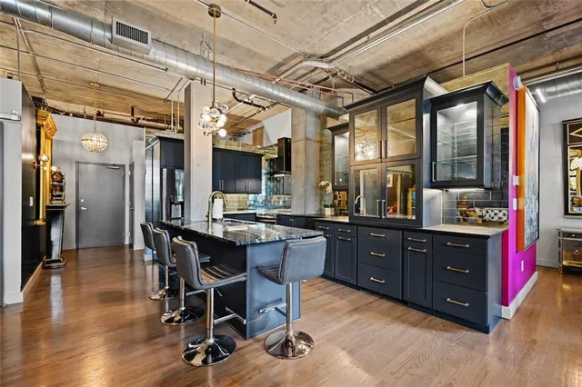 a living room with furniture a flat screen tv and a floor to ceiling window