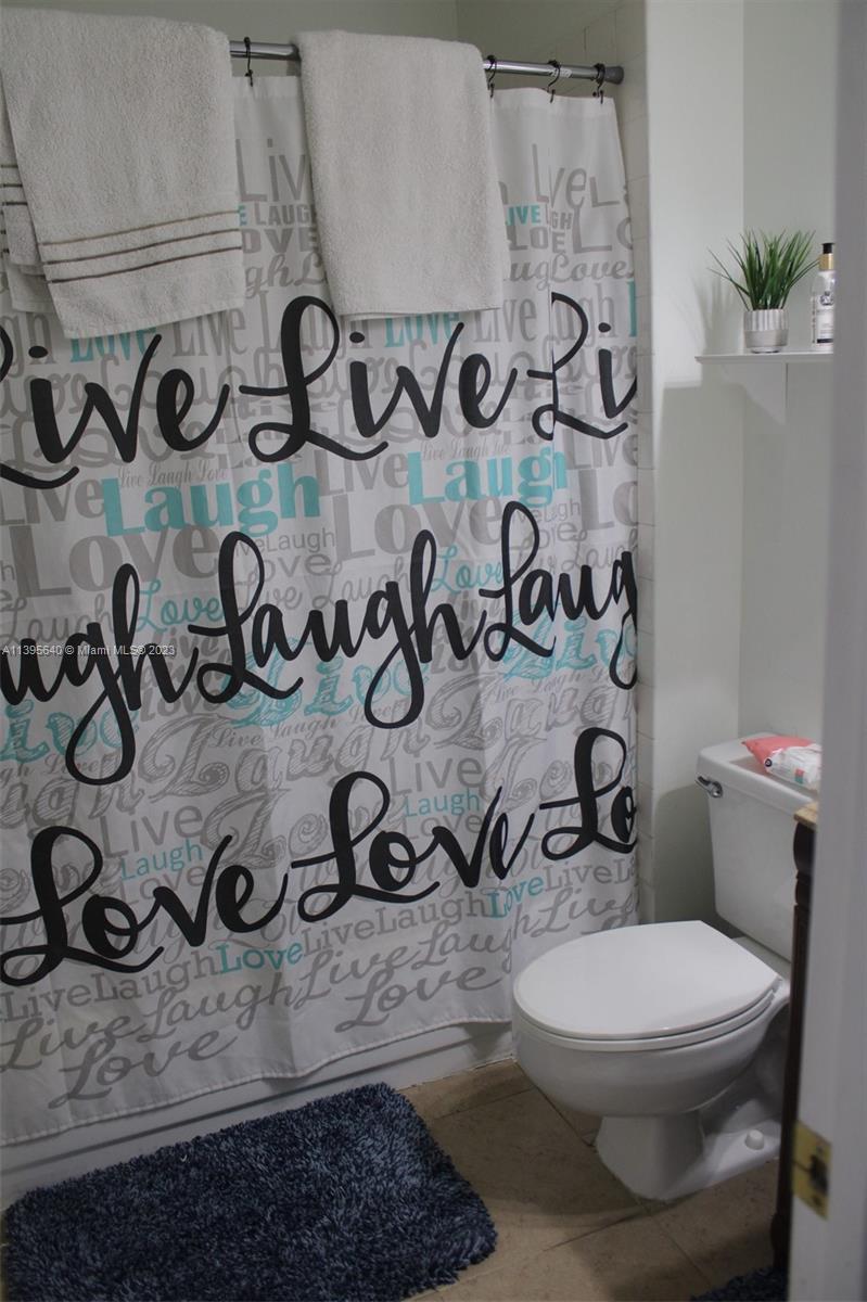 13475 Southwest 62nd Street, Unit 5 Miami, FL 33183 - Photo 12 of 32 a bathroom with a toilet and a shower