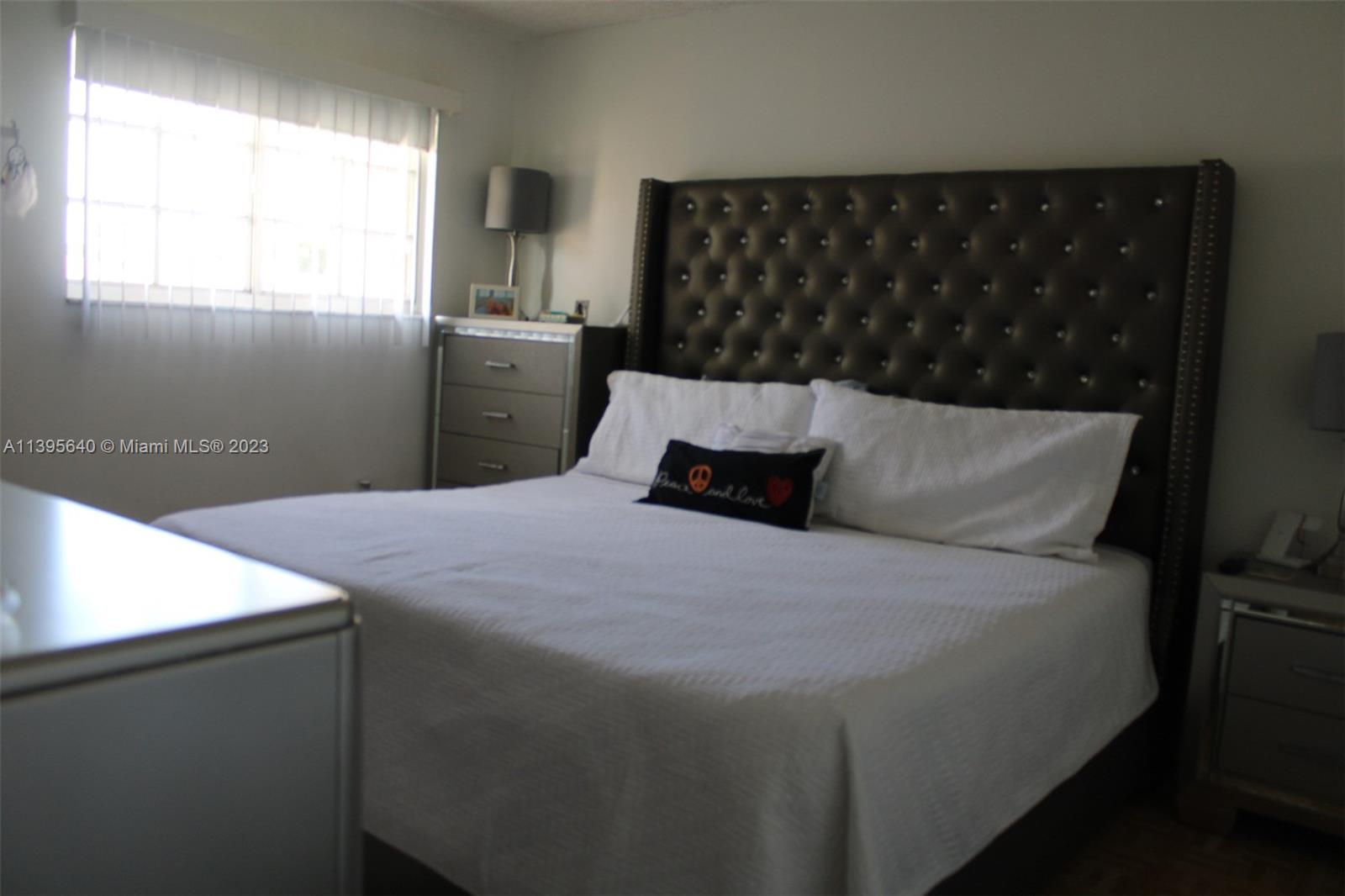 13475 Southwest 62nd Street, Unit 5 Miami, FL 33183 - Photo 14 of 32 a bedroom with a bed and window