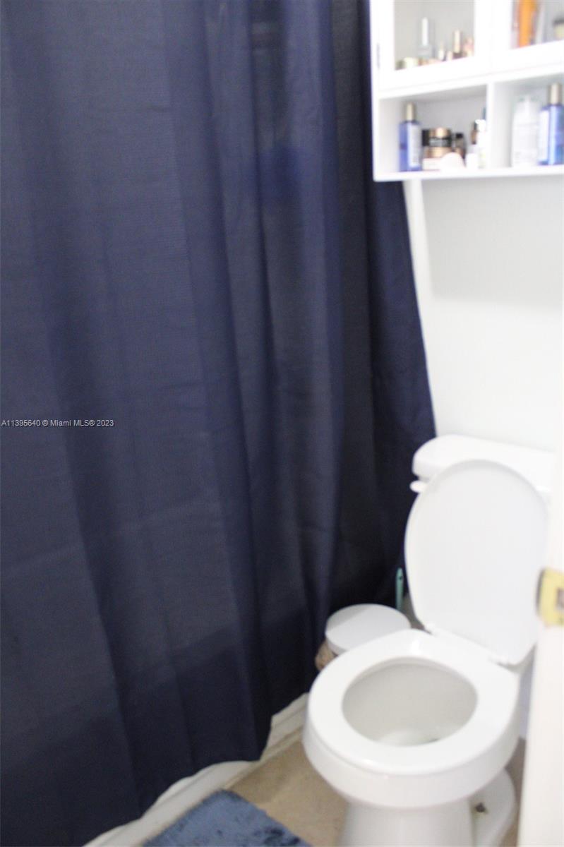 13475 Southwest 62nd Street, Unit 5 Miami, FL 33183 - Photo 16 of 32 a bathroom with a toilet and a sink