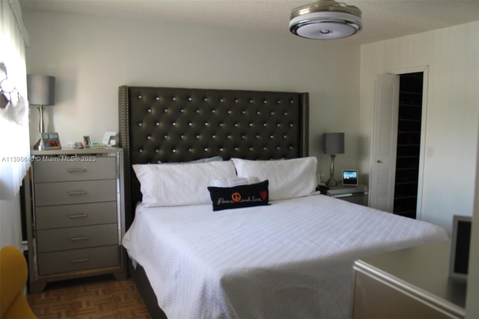 13475 Southwest 62nd Street, Unit 5 Miami, FL 33183 - Photo 18 of 32 a bedroom with a bed and cabinet