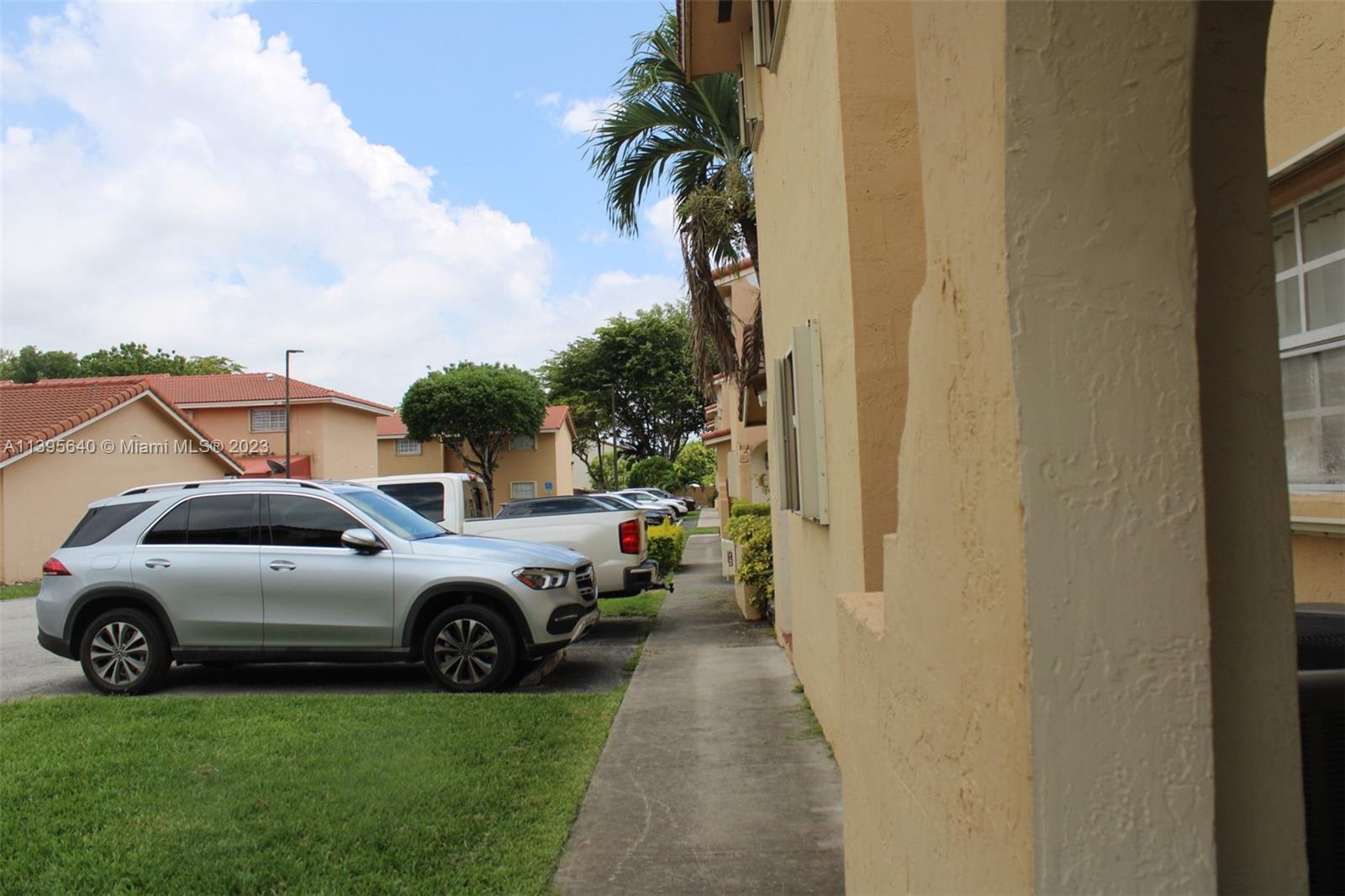 13475 Southwest 62nd Street, Unit 5 Miami, FL 33183 - Photo 2 of 32 a view of a cars parked in back of a house