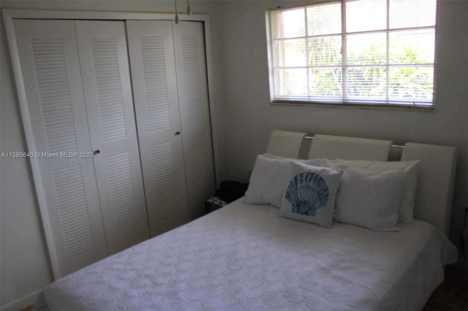 13475 Southwest 62nd Street, Unit 5 Miami, FL 33183 - Photo 26 of 32 a bedroom with a bed and a window
