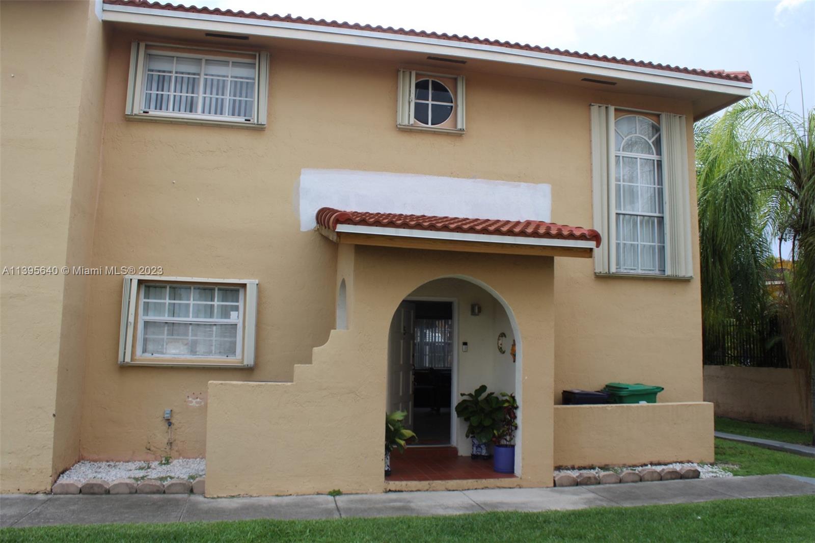 13475 Southwest 62nd Street, Unit 5 Miami, FL 33183 - Photo 3 of 32 a front view of a house with garden