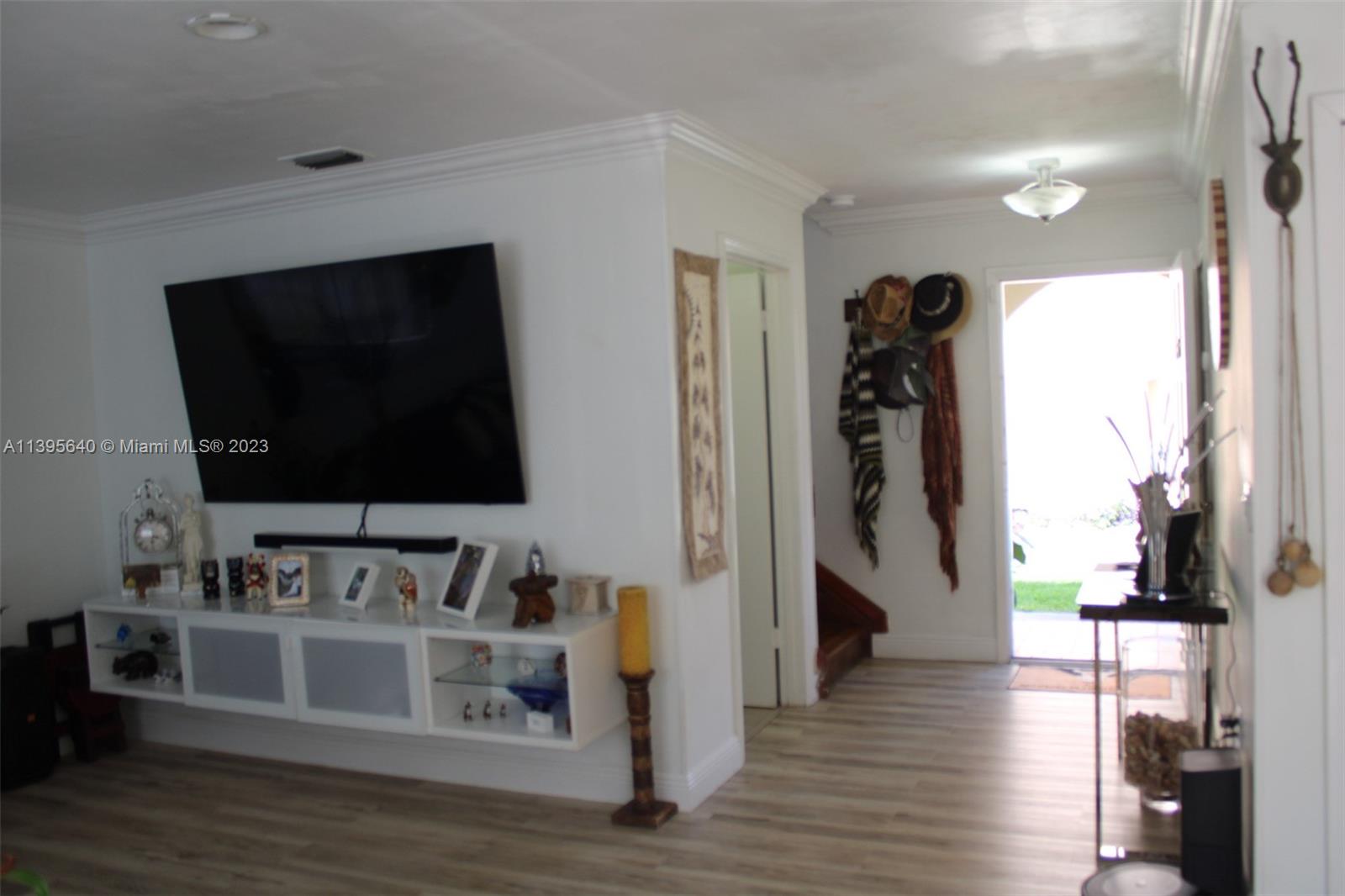 13475 Southwest 62nd Street, Unit 5 Miami, FL 33183 - Photo 32 of 32 a living room with stainless steel appliances furniture and a flat screen tv