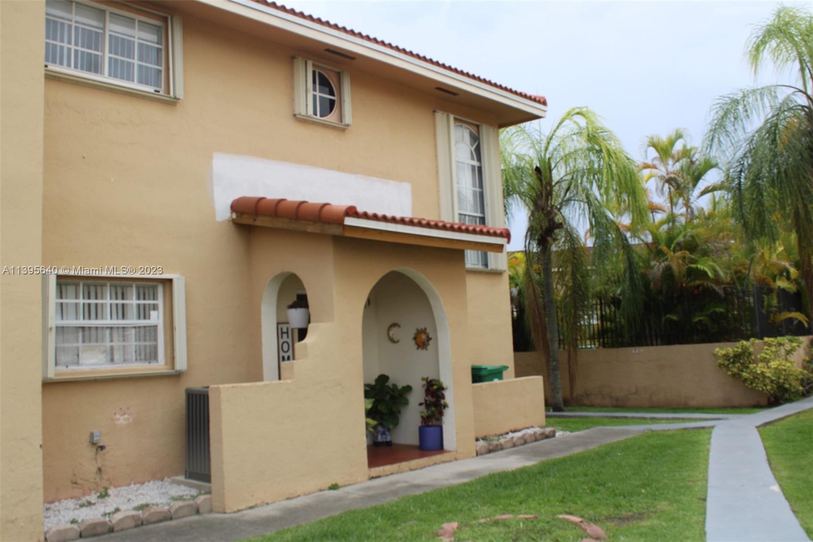 13475 Southwest 62nd Street, Unit 5 Miami, FL 33183 - Photo 4 of 32 a front view of a house with garden