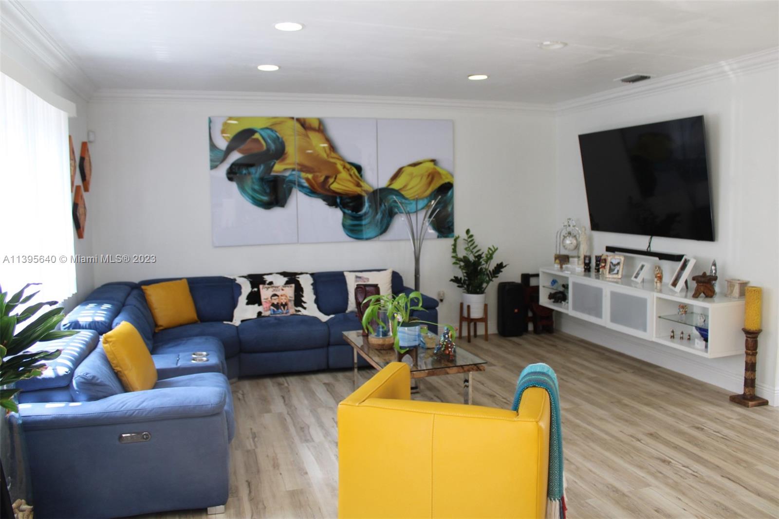 13475 Southwest 62nd Street, Unit 5 Miami, FL 33183 - Photo 6 of 32 a living room with furniture and a flat screen tv