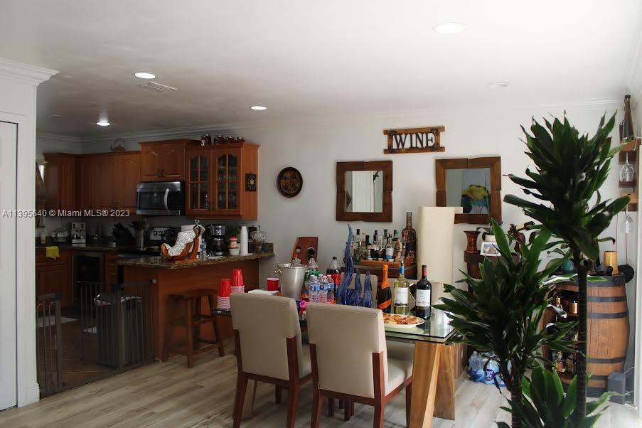 13475 Southwest 62nd Street, Unit 5 Miami, FL 33183 - Photo 7 of 32 a kitchen with a table and chairs in it