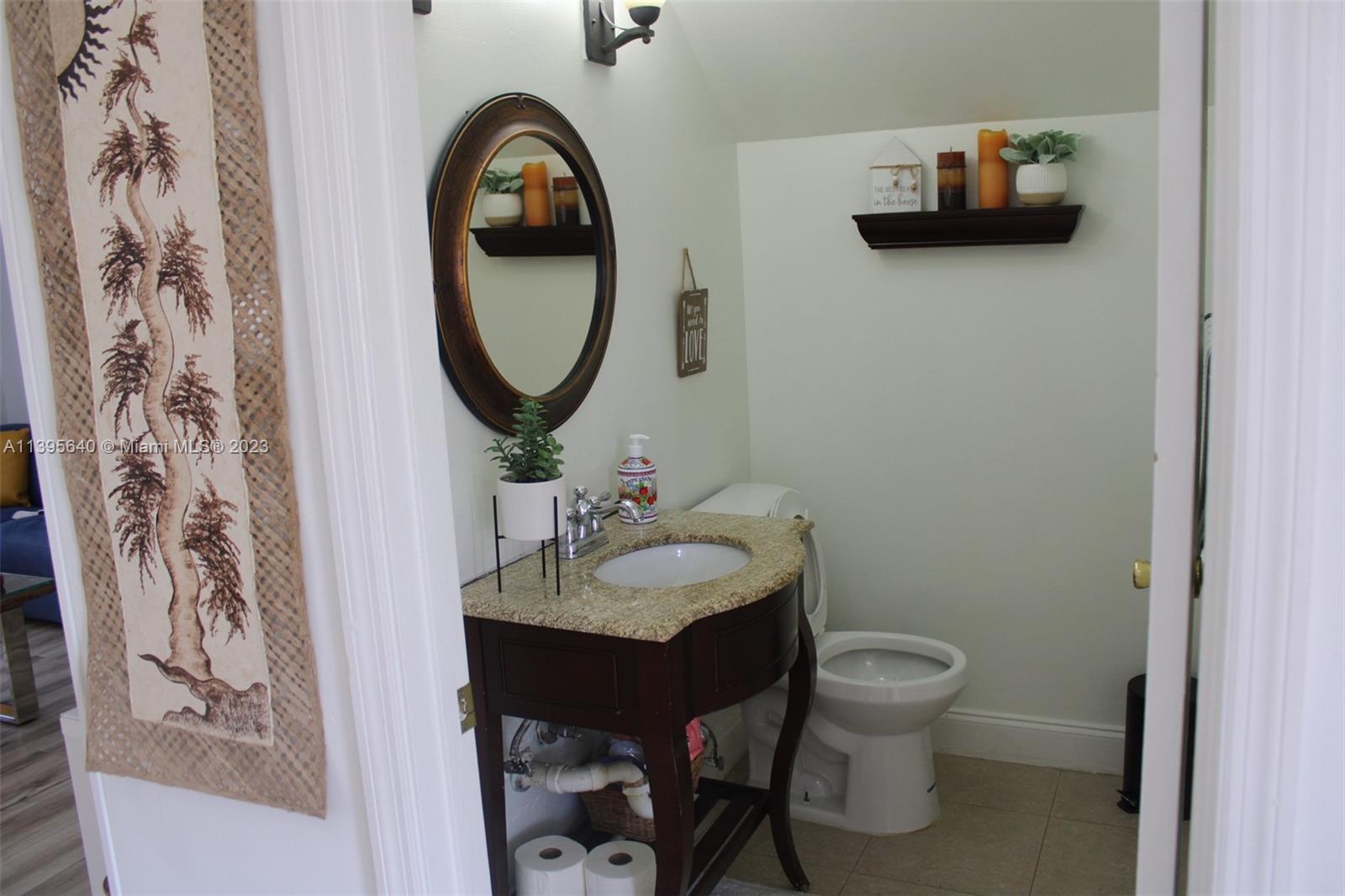 13475 Southwest 62nd Street, Unit 5 Miami, FL 33183 - Photo 8 of 32 a bathroom with a toilet sink and mirror