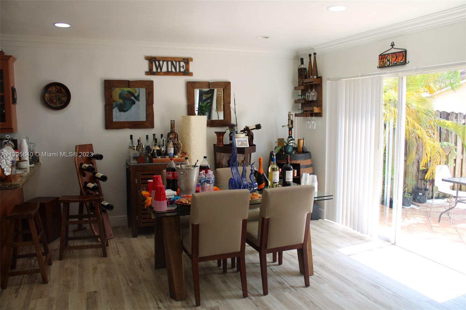 13475 Southwest 62nd Street, Unit 5 Miami, FL 33183 - Photo 9 of 32 a view of a dining room with furniture and wooden floor