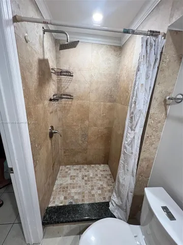 a bathroom with a toilet and shower