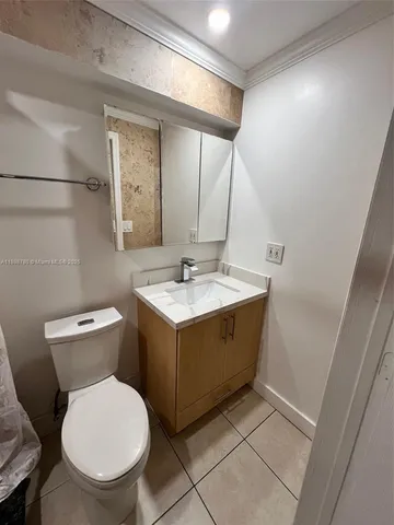 a bathroom with a sink toilet and mirror