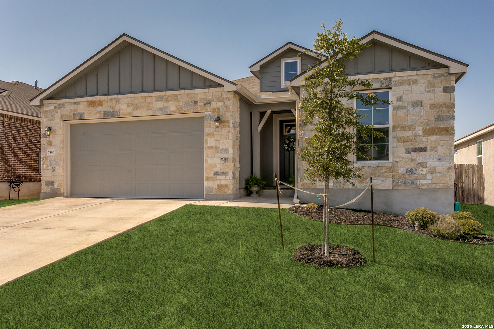 a front view of a house with a yard and garage