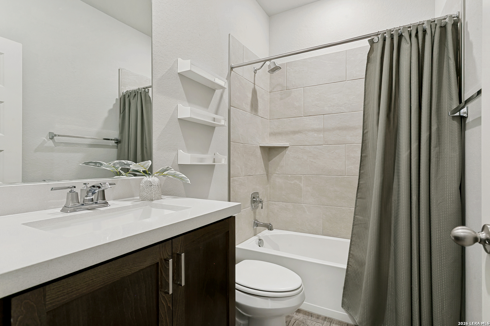 7350 Walkers Loop Live Oak, TX 78233 - Photo 15 of 23 a bathroom with a sink a toilet a mirror and shower