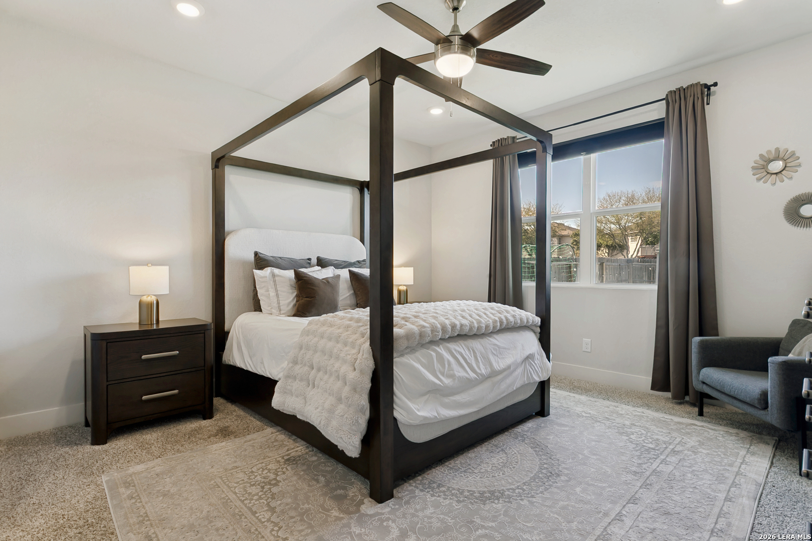7350 Walkers Loop Live Oak, TX 78233 - Photo 16 of 23 a bedroom with a bed mirror and a large window
