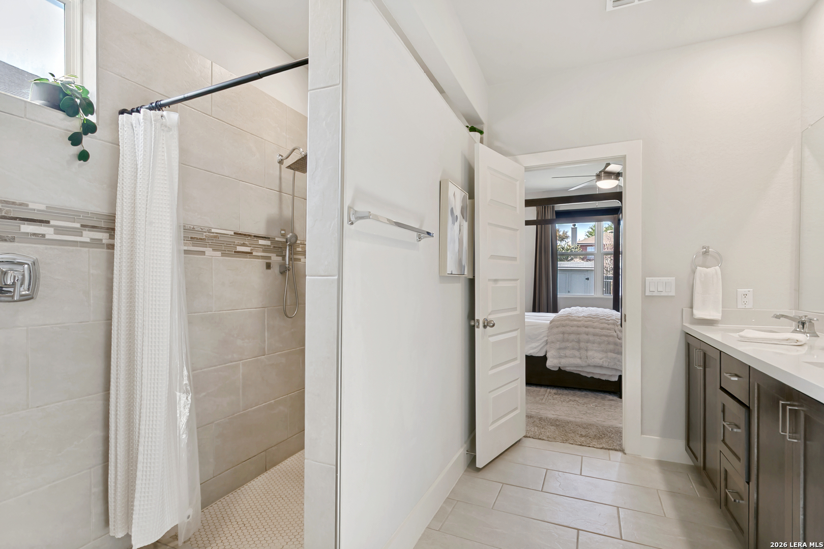 7350 Walkers Loop Live Oak, TX 78233 - Photo 18 of 23 a en suite bathroom with a tub shower and sink