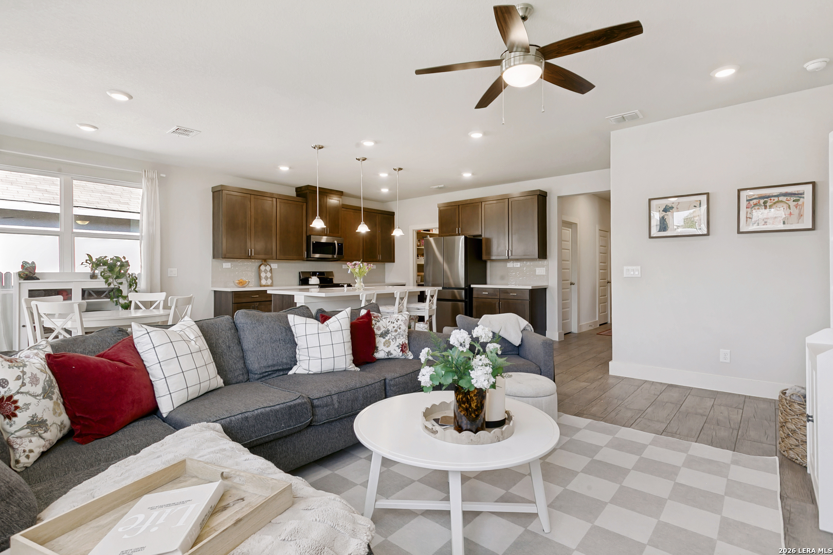 7350 Walkers Loop Live Oak, TX 78233 - Photo 7 of 23 a living room with furniture kitchen and a chandelier