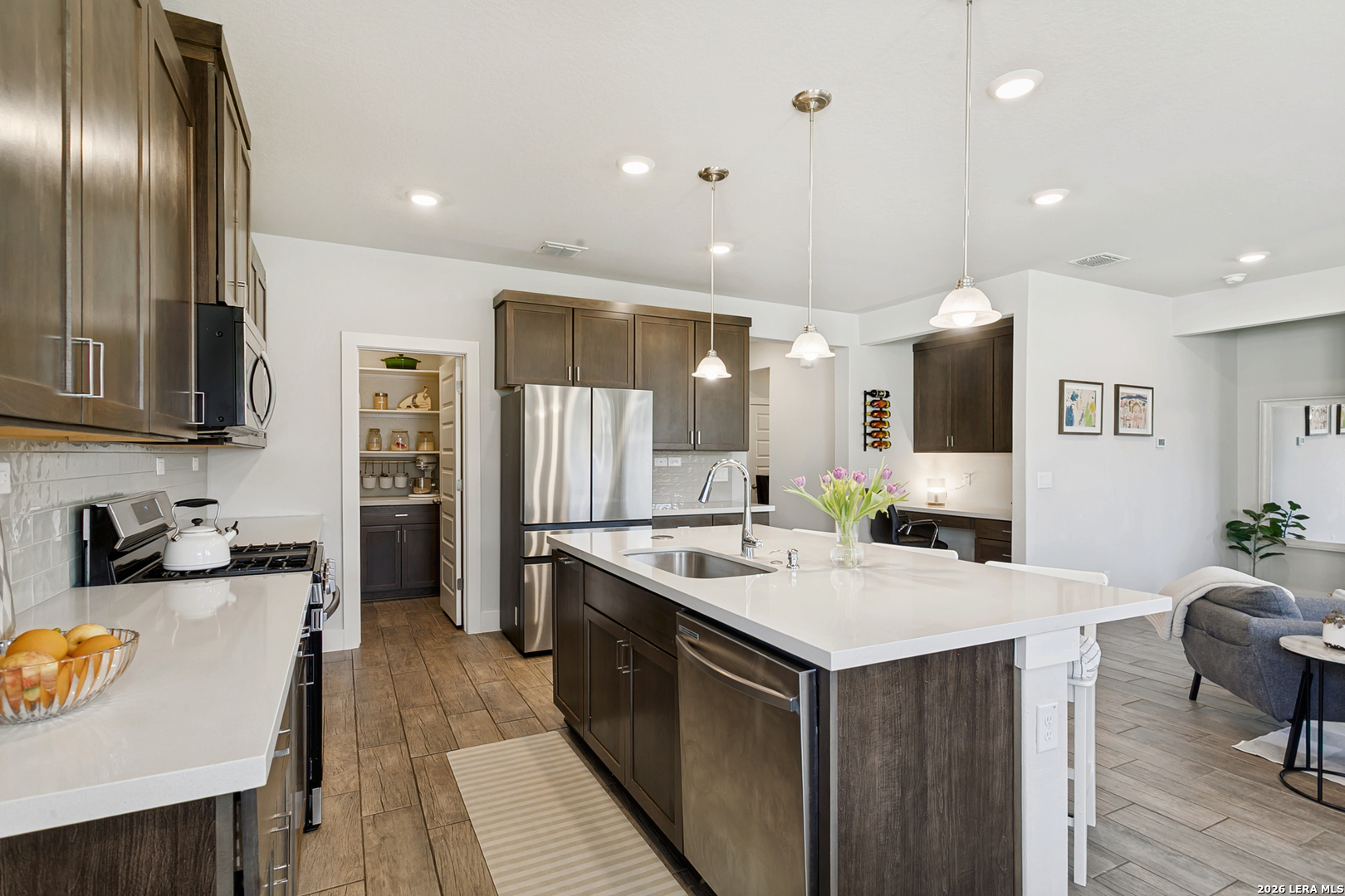 7350 Walkers Loop Live Oak, TX 78233 - Photo 10 of 23 a kitchen with a sink stove and refrigerator
