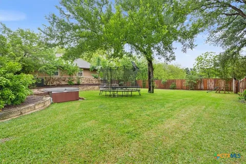 a view of a swimming pool with a yard