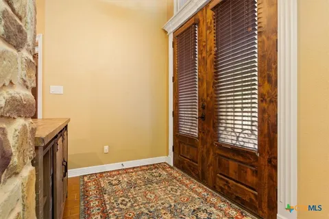 a view of an empty room and a window
