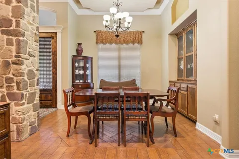 a view of a dining room with furniture and a chandelier